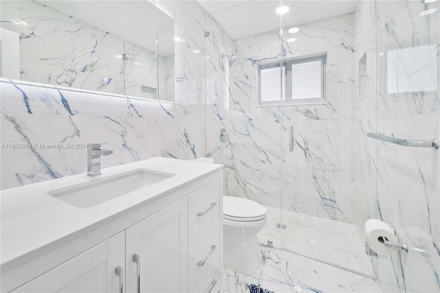 bathroom featuring tile walls, vanity, toilet, and a shower with door