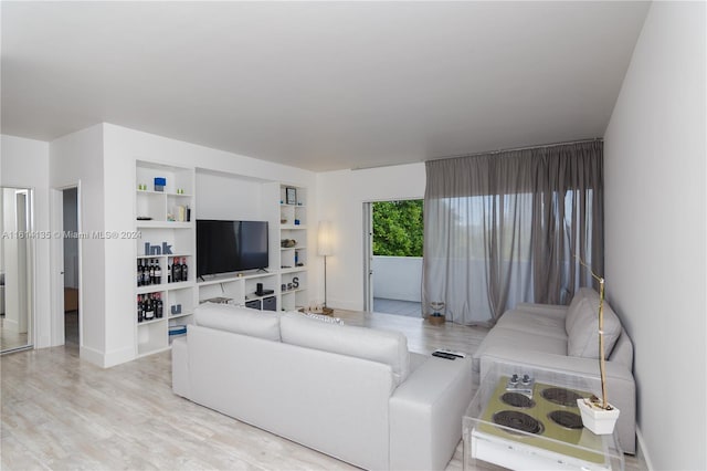 3 Island Ave Unit 04J, Miami Beach, FL 33139 - living room featuring wood finished floors, baseboards, and built in shelves