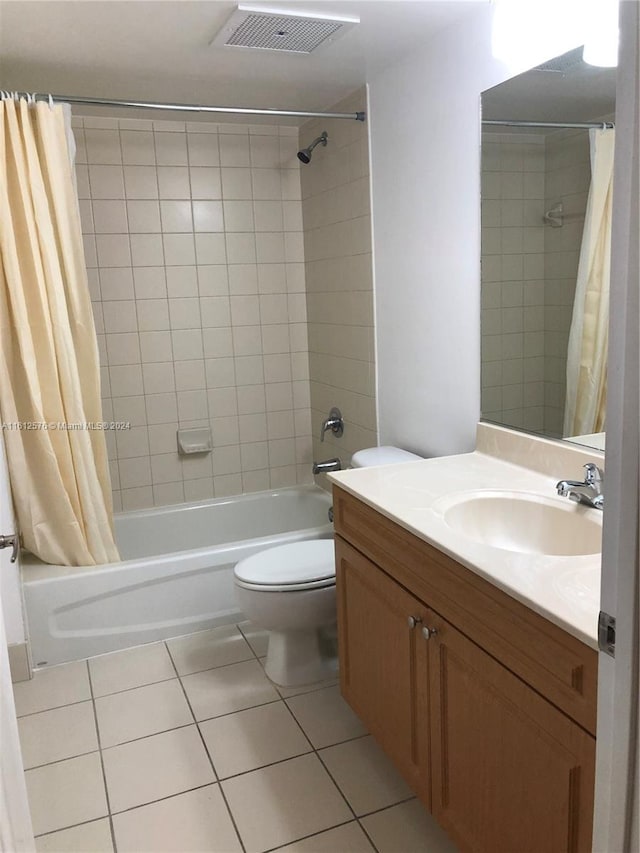 full bathroom featuring shower / tub combo with curtain, tile patterned floors, vanity, and toilet