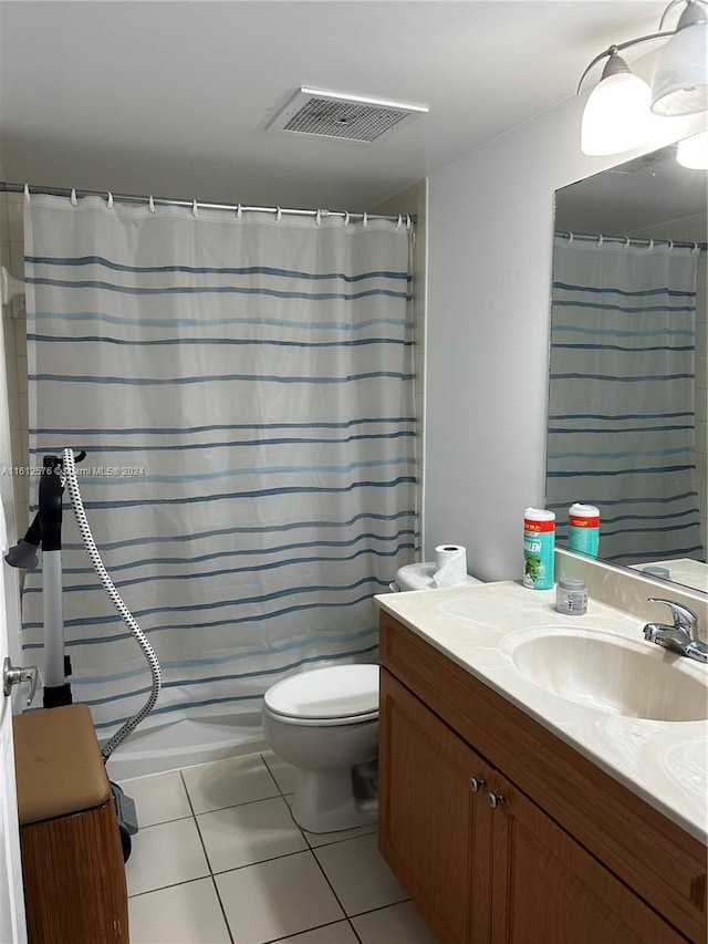 bathroom with tile patterned flooring, a shower with curtain, vanity, and toilet