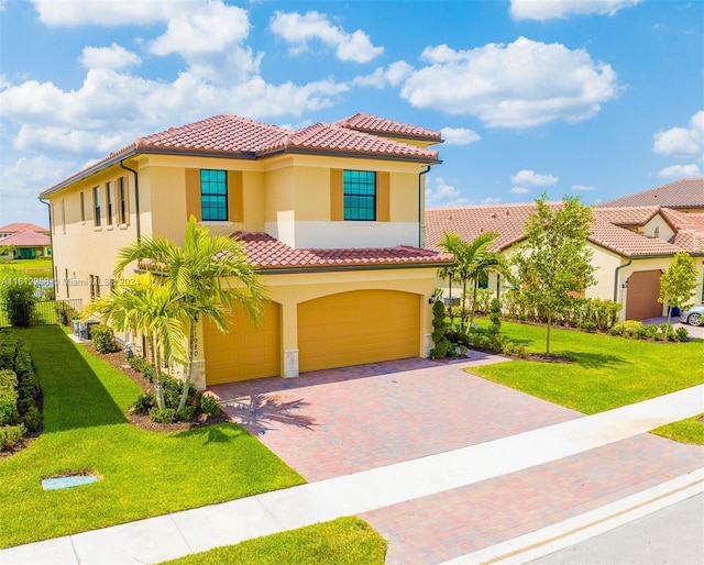 mediterranean / spanish-style home with a front yard and a garage