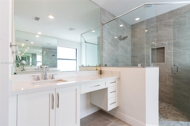 bathroom featuring tile patterned flooring, vanity, and an enclosed shower