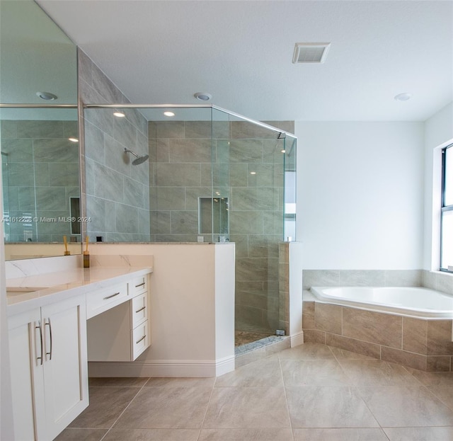 bathroom featuring vanity, tile patterned floors, and independent shower and bath