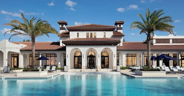 back of house featuring a patio area and a community pool