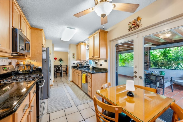 kitchen featuring light brown cabinets, french doors, sink, light tile patterned floors, and appliances with stainless steel finishes