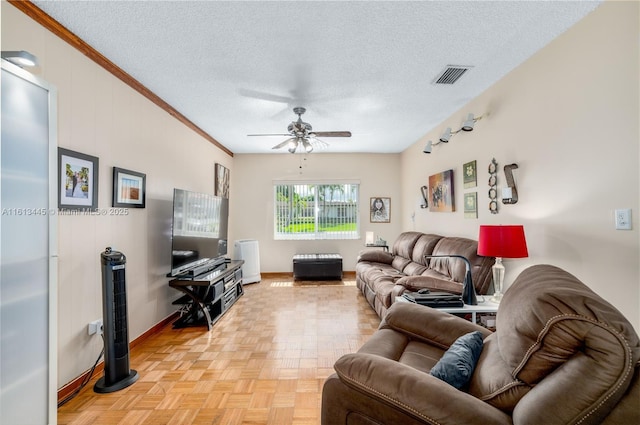 living room with ceiling fan, a textured ceiling, and light parquet flooring