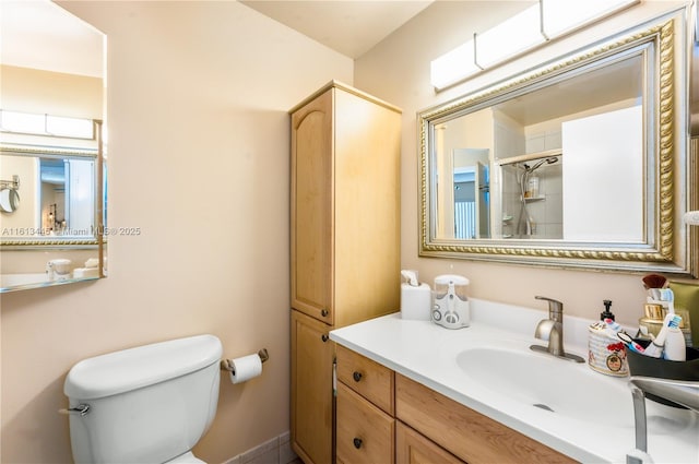 bathroom with vanity, toilet, and a shower