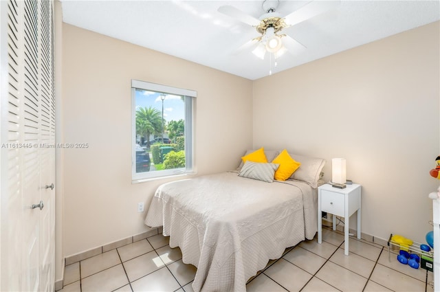 bedroom featuring ceiling fan and light tile patterned floors