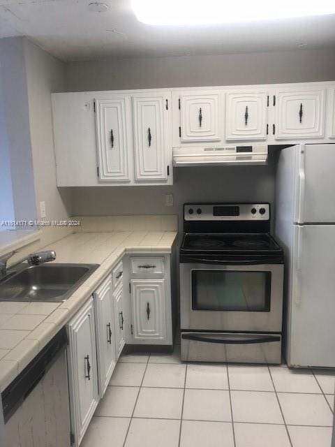 kitchen with stainless steel appliances, white cabinetry, and sink