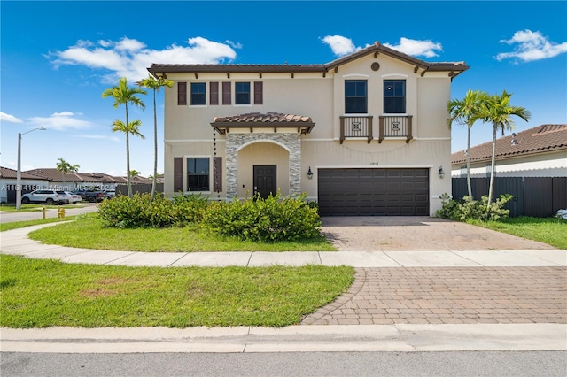 mediterranean / spanish-style house with a garage