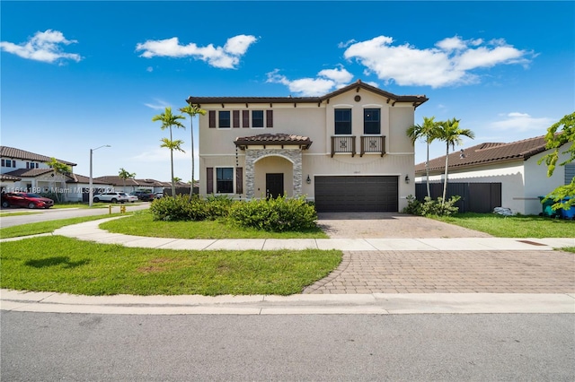 mediterranean / spanish-style house with a garage and a front lawn