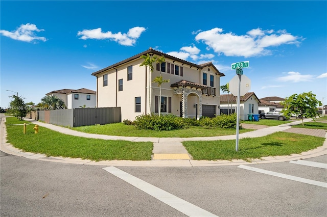 mediterranean / spanish house with a garage and a front yard