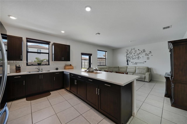 kitchen with dark brown cabinetry, sink, and kitchen peninsula