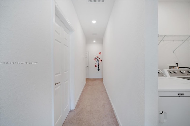 hall featuring light carpet and washing machine and dryer