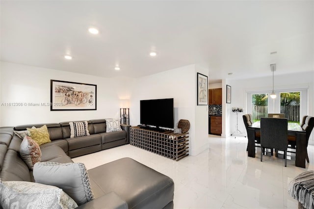 living room featuring marble finish floor and recessed lighting