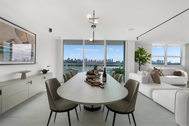 dining space with a water view and a wall of windows