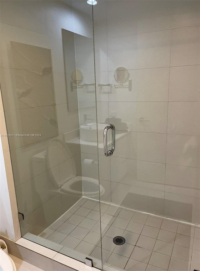 bathroom featuring an enclosed shower and toilet