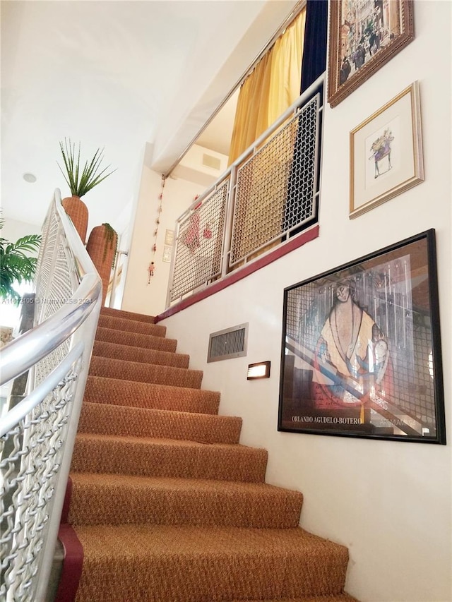 stairway featuring visible vents