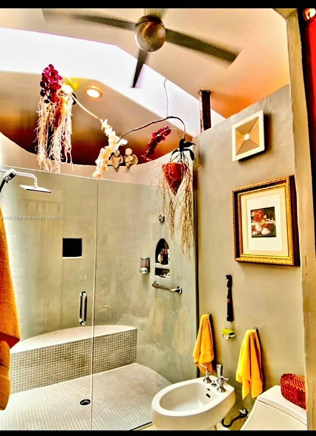 bathroom featuring sink, toilet, a bidet, and a shower with shower door