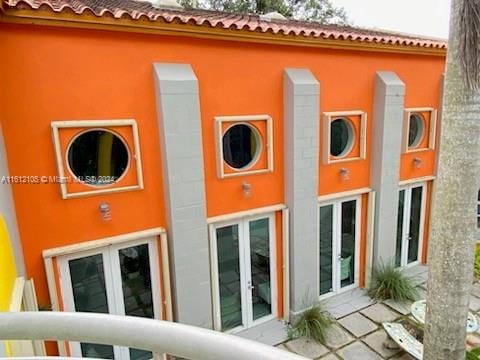 view of side of property with french doors