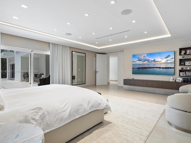 bedroom with a raised ceiling and access to outside