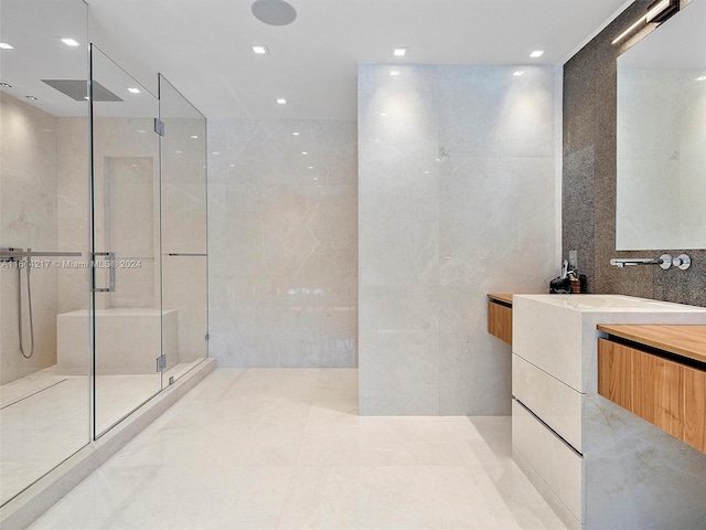 bathroom featuring tile walls, vanity, and walk in shower