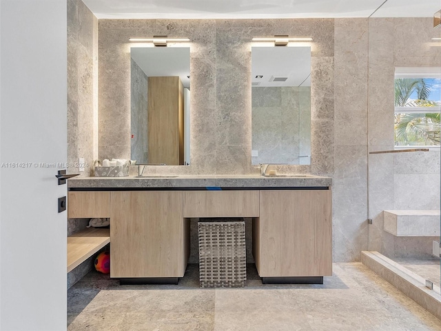 bathroom with vanity and tile walls