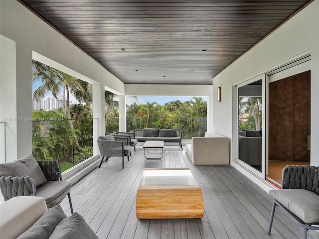 wooden terrace with an outdoor hangout area