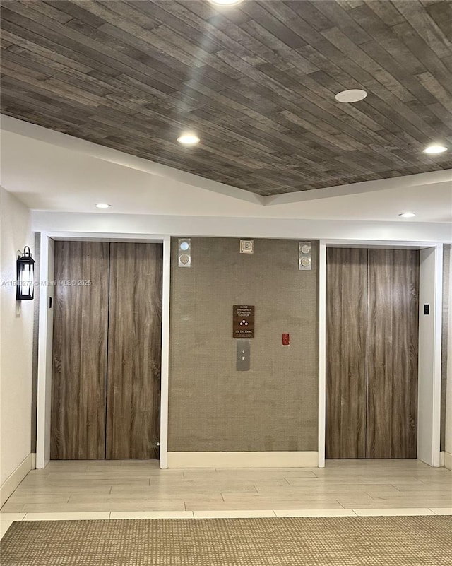 finished basement with wood finish floors, wooden ceiling, and recessed lighting