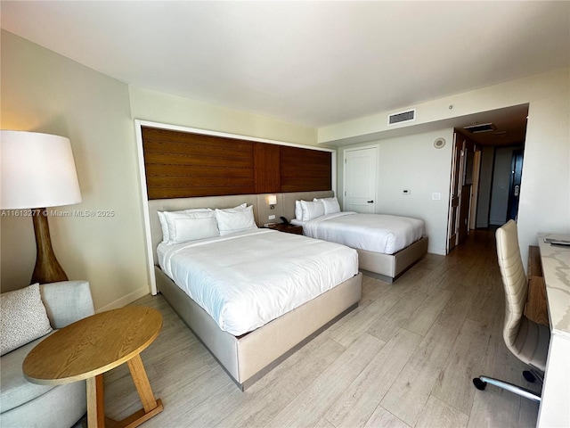 bedroom featuring light wood-type flooring and visible vents