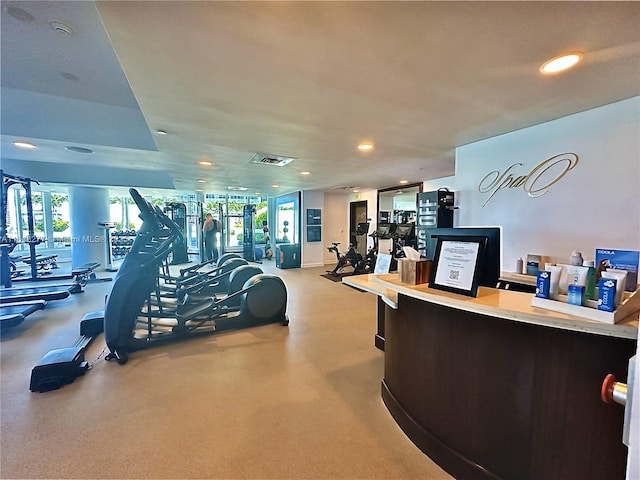 exercise room with recessed lighting, visible vents, and plenty of natural light