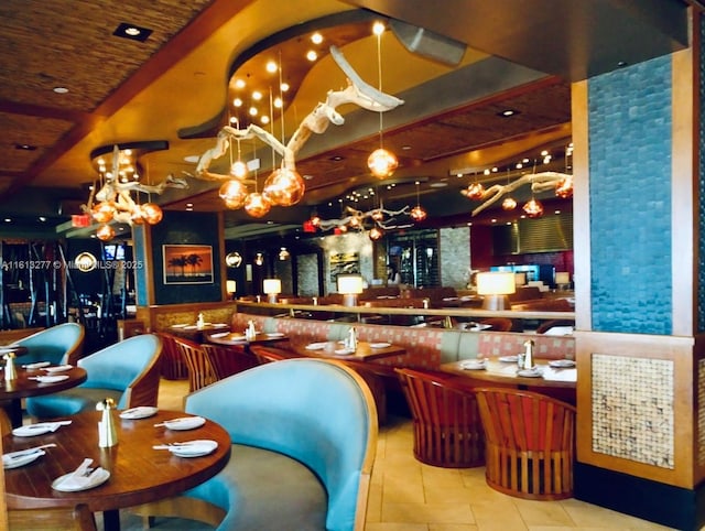 bar with tile patterned floors and a notable chandelier