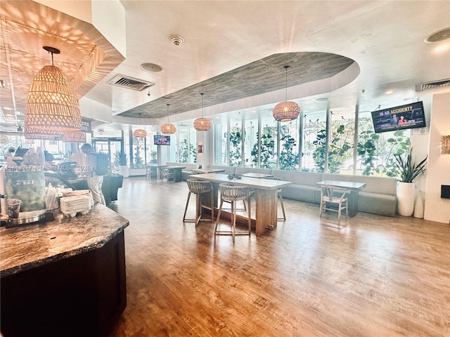 interior space featuring wood finished floors, visible vents, and a wealth of natural light