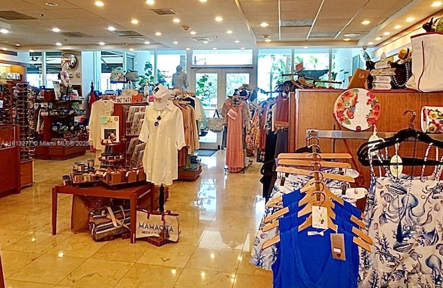 interior space featuring light tile patterned floors, visible vents, and a paneled ceiling