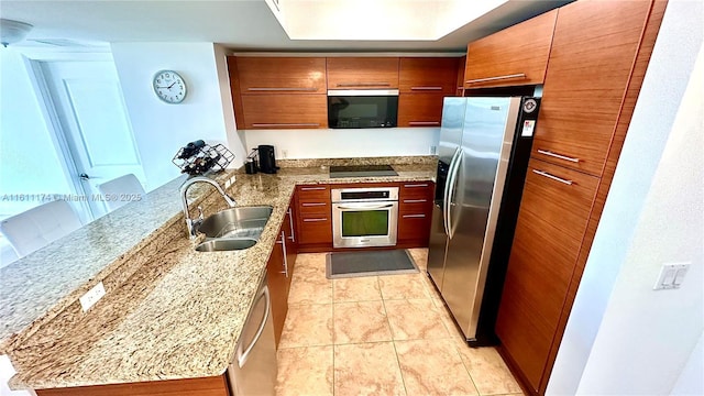 kitchen with light tile patterned floors, sink, light stone counters, and stainless steel appliances