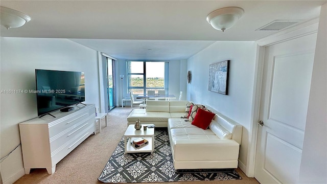 living room with floor to ceiling windows and carpet floors