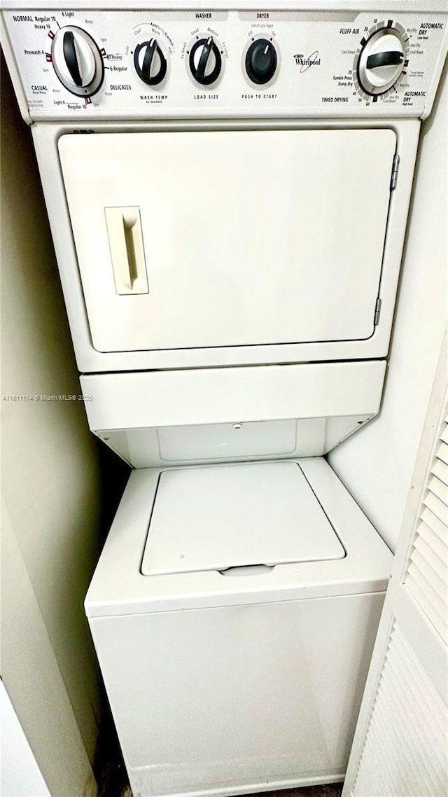 laundry room with stacked washing maching and dryer