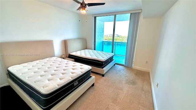 carpeted bedroom featuring ceiling fan and access to exterior