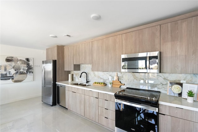 kitchen with appliances with stainless steel finishes, tasteful backsplash, sink, light brown cabinets, and light tile patterned floors