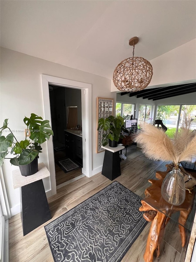 corridor with lofted ceiling and light hardwood / wood-style floors