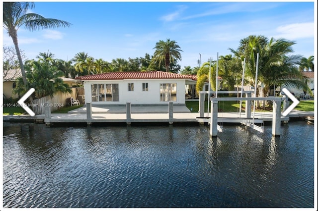 view of dock with a patio and a water view