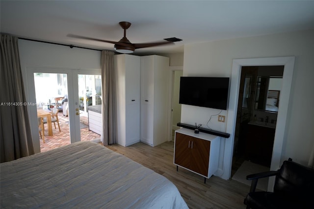 bedroom with light hardwood / wood-style floors, french doors, ensuite bath, access to exterior, and ceiling fan