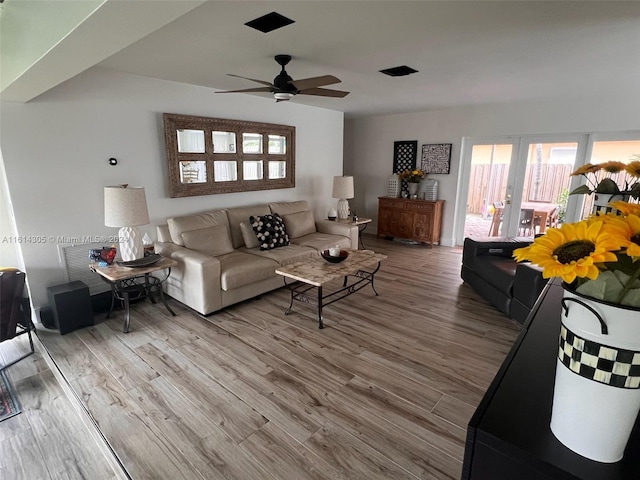 living room featuring ceiling fan and hardwood / wood-style floors