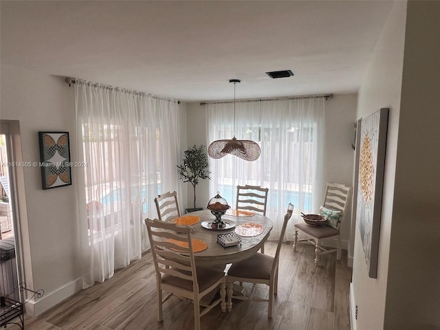 dining space with hardwood / wood-style flooring