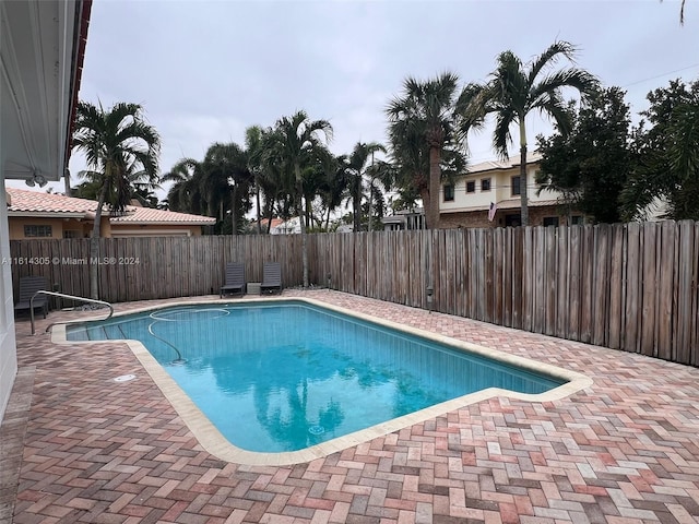 view of swimming pool with a patio area