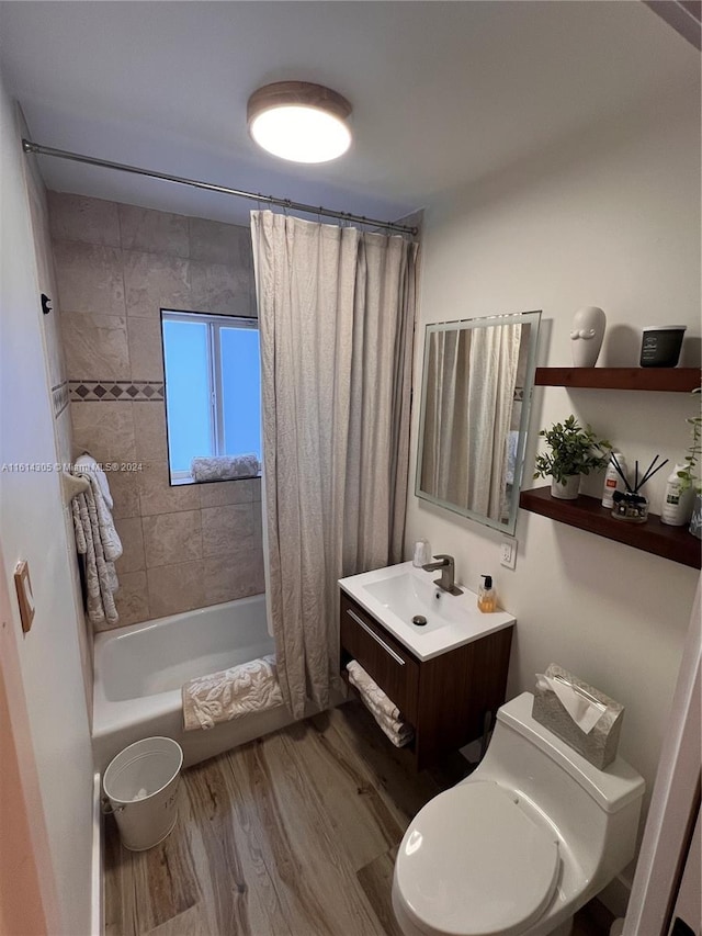 full bathroom featuring vanity, hardwood / wood-style flooring, toilet, and shower / tub combo