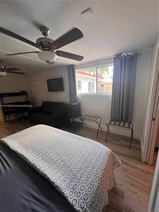 bedroom with ceiling fan and wood-type flooring