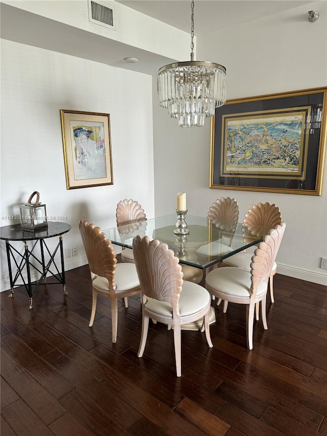 dining room featuring dark hardwood / wood-style flooring and a chandelier