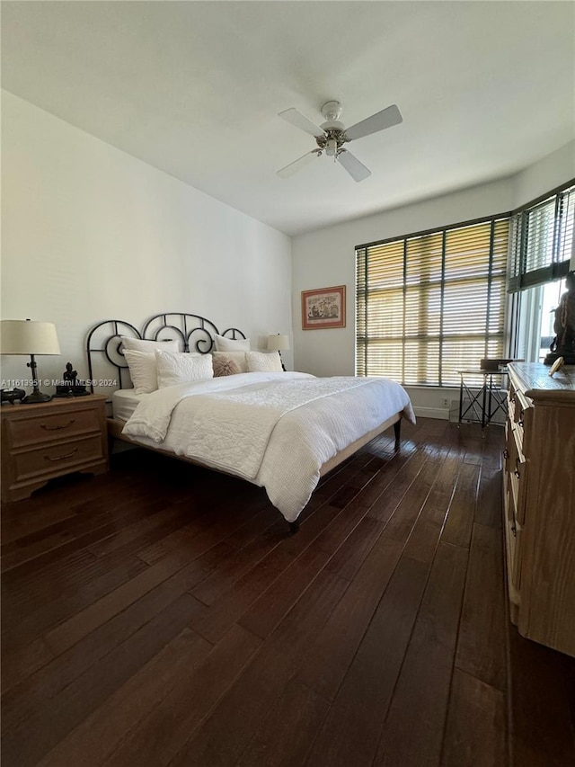 bedroom with dark wood-type flooring and a ceiling fan