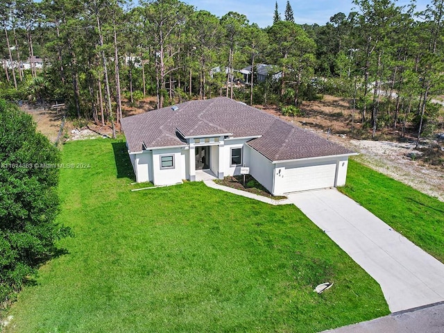 view of front of house with a garage and a front yard